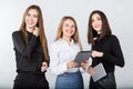 Three smiling business women standing in a row isolated on white background. Business Group people. Happy Business Team. Royalty Free Stock Photo