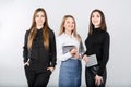 Three smiling business women standing in a row isolated on white background. Business Group people. Happy Business Team. Royalty Free Stock Photo