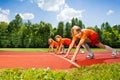 Three smiling children in ready position to run Royalty Free Stock Photo