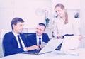 Three smiling coworkers different sexes working on computers tog Royalty Free Stock Photo