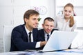 Three smiling coworkers working in company office Royalty Free Stock Photo