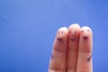 Three smiling fingers that are very happy to be friends. Friendship teamwork concept on blue background with copy space Royalty Free Stock Photo