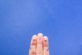 Three smiling fingers that are very happy to be friends. Friendship teamwork concept on blue background with copy space Royalty Free Stock Photo