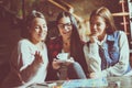 Three smiling girls playing board game. Royalty Free Stock Photo