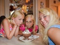 Three Smiling Girls Share a Dessert