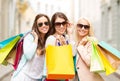 Three smiling girls with shopping bags in ctiy Royalty Free Stock Photo