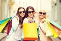 Three smiling girls with shopping bags in ctiy Royalty Free Stock Photo