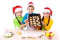 Three smiling kids with Christmas cooking Royalty Free Stock Photo