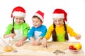 Three smiling kids with Christmas cooking