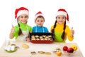 Three smiling kids with Christmas cooking Royalty Free Stock Photo