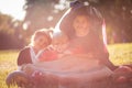 Three smiling kids sitting on grass in Halloween suits Royalty Free Stock Photo