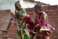 Three Smiling Little African Girls Busy Fetching Water At The Village Pump Royalty Free Stock Photo