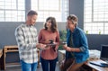 Smiling office coworkers using a tablet during their coffee break Royalty Free Stock Photo