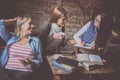 Three students girls having conversation in cafe. Royalty Free Stock Photo