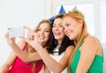 Three smiling women in hats having fun with camera Royalty Free Stock Photo