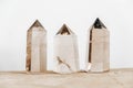 Three smoky natural quartz crystals on a wooden surface on a white background. Copy, empty space for text