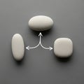 Three smooth, oval-shaped stones are arranged on a gray surface Royalty Free Stock Photo