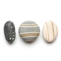 Three smooth pebbles placed in a row against a white background Royalty Free Stock Photo