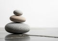 Three smooth stones are stacked in a pyramid shape on a Royalty Free Stock Photo
