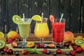 Three smoothies from different fruits and berries such as kiwi, orange, peach, apricot, cherry, strawberry, raspberry Royalty Free Stock Photo
