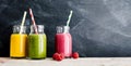 Three smoothies in jars on table Royalty Free Stock Photo