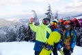 Three snowboarders taking selfie with smartphone camera at ski resort. Friends photographing for social network sharing