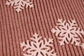 three snowflake decorations lie on a wooden floor
