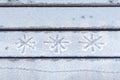 Three snowflake inscription on frozen bench