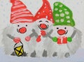 Three snowmen in caps of green and red colors with a flashlight