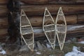 Three snowshoe at the wall of the wooden house