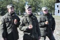 Three soldiers standing and eating apples. Novo-Petrivtsi military base, Ukraine