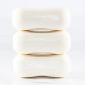 A close up of three pure white bar of soap.