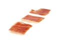 Three spanish serrano ham slices isolated on white Royalty Free Stock Photo