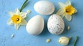 Three speckled Easter eggs with yellow and white daffodils Royalty Free Stock Photo