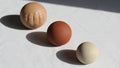 The right sphere is light beige and smooth with slight speckles Royalty Free Stock Photo