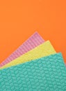 Three sponges for cleaning on orange Royalty Free Stock Photo