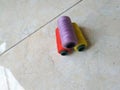 Three spools of colored thread on floor background.