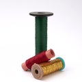 Three spools of colored thread on a white background Royalty Free Stock Photo