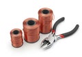 Three spools of copper wire at different heights are arranged in ascending order. Royalty Free Stock Photo