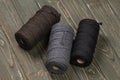 Three spools of cotton ropes of different colors.