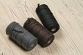 Three spools of cotton ropes of different colors.
