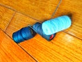 three spools of yarn in white, black and dark blue