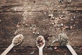 Three spoons filled with dried herbs for tea on a wooden table Royalty Free Stock Photo