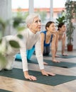 Three sports women practice cow pose