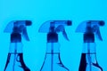 Three Spray Bottles With Blue Light Royalty Free Stock Photo