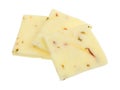 Three squares of pepper jack cheese on a white background