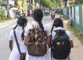 Three sri lankan school girls in uniform walking on the street after classes