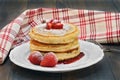 Three stacked pancakes with fresh strawberries on a vintage wood Royalty Free Stock Photo