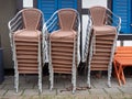 Three stacks of chairs standing side by side. A stack of chairs tied with an old rusty chain. Restaurant closed due to lockdown. Royalty Free Stock Photo