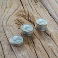 Three stacks of coins on the wooden table.